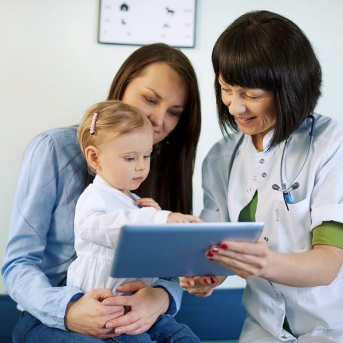 Doctor showing mother's medical results on the tablet