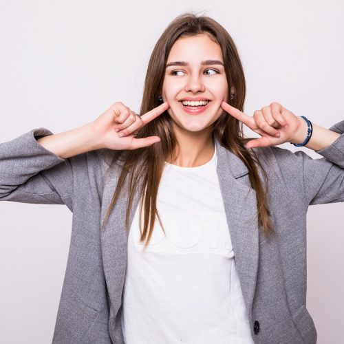 Woman showing her perfect straight white teeth.